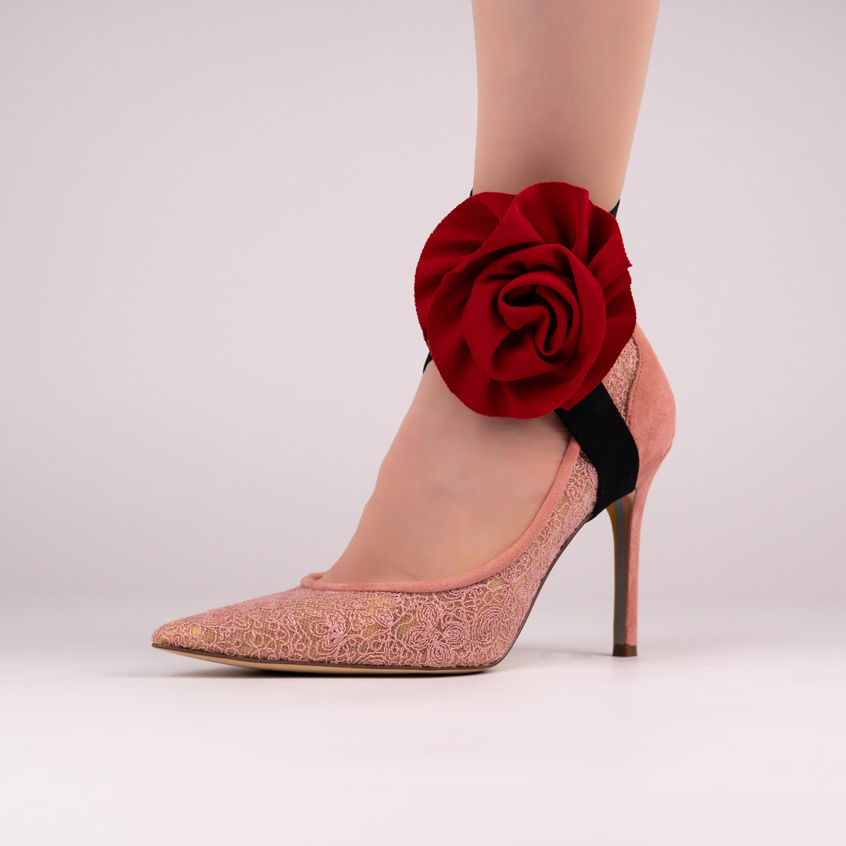 Red rose LYNKS straps styled on a pink lace pointed-toe pump
