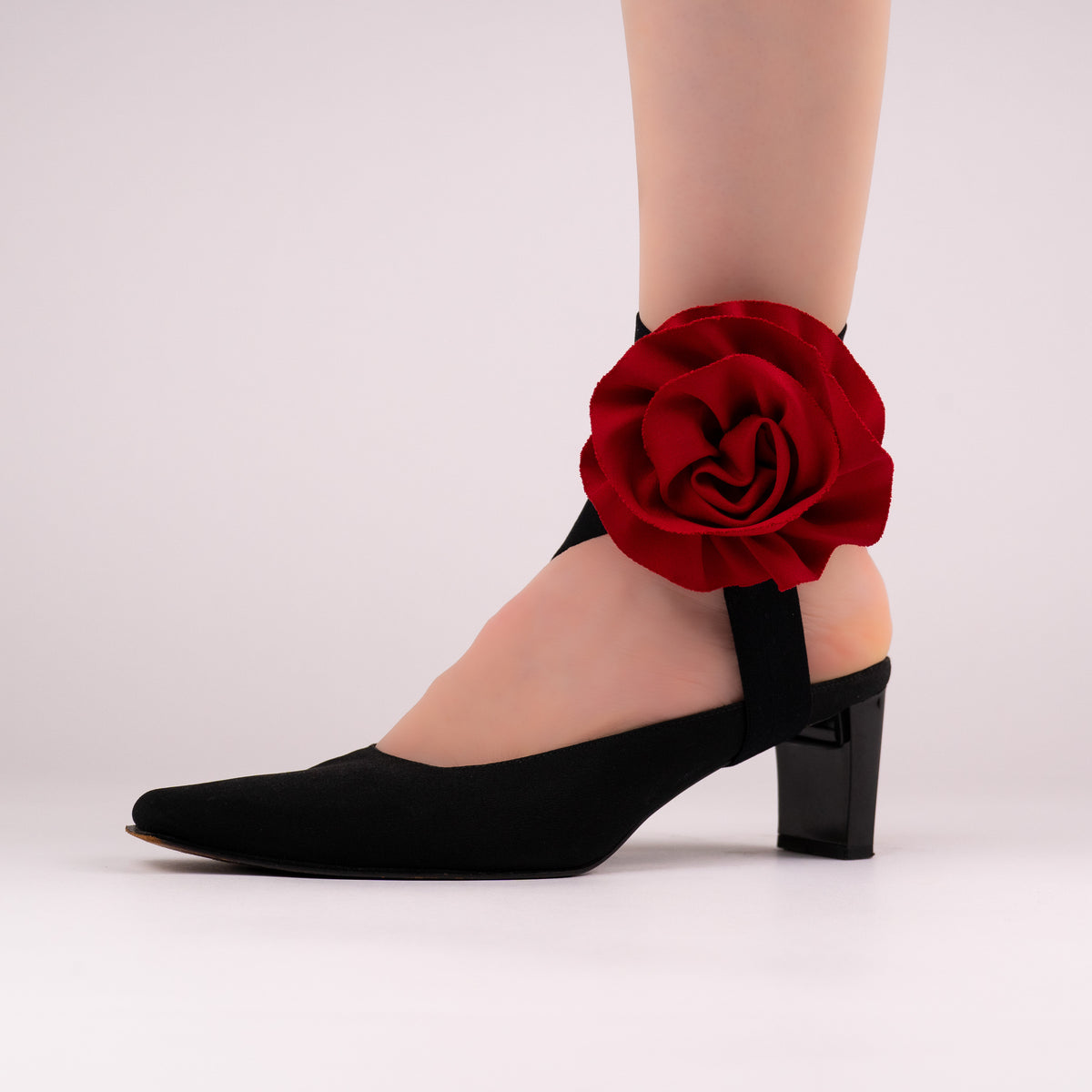 Red rose LYNKS straps styled on a black closed-toe block heel