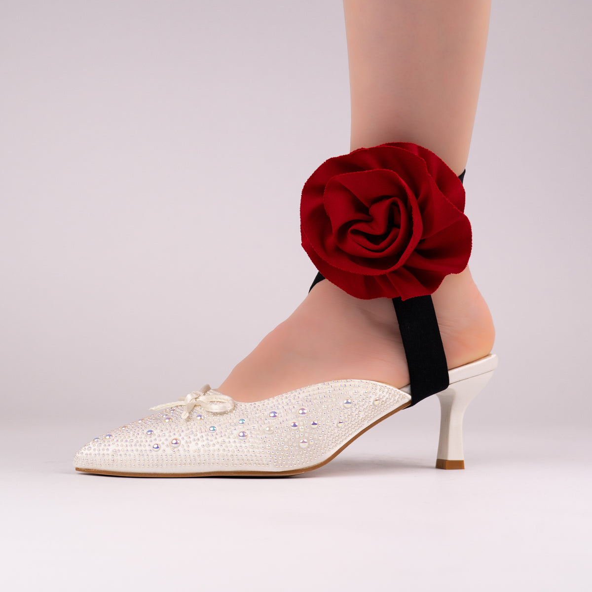 Red rose LYNKS straps styled on a white rhinestone low heel