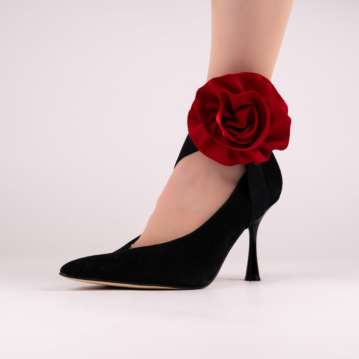 Red rose LYNKS straps styled on a black pointed-toe pump
