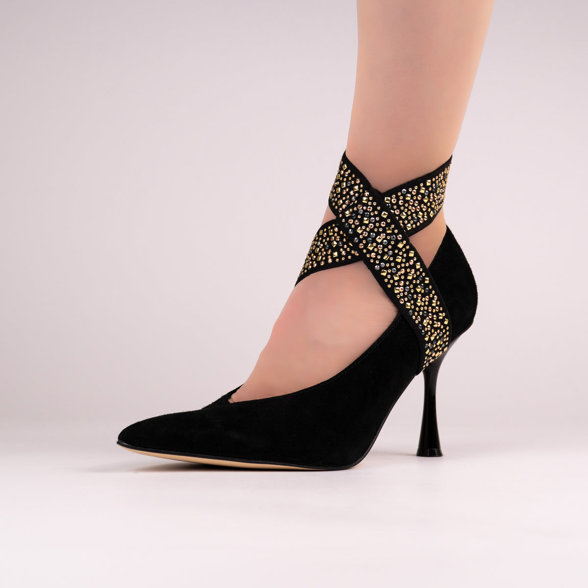 Jeweled black LYNKS straps styled on a black pointed-toe pump