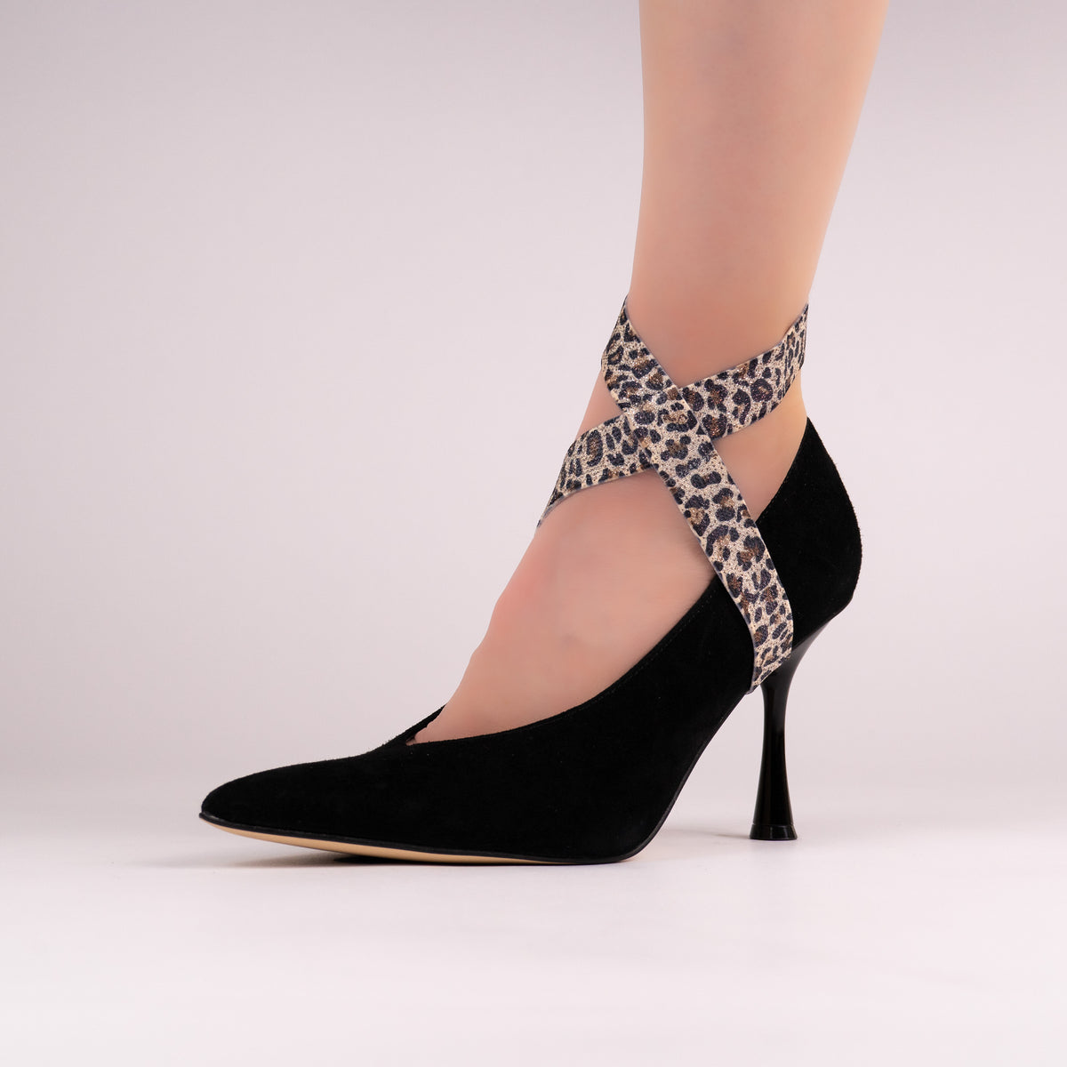 Leopard-print LYNKS straps styled on a black pointed-toe pump