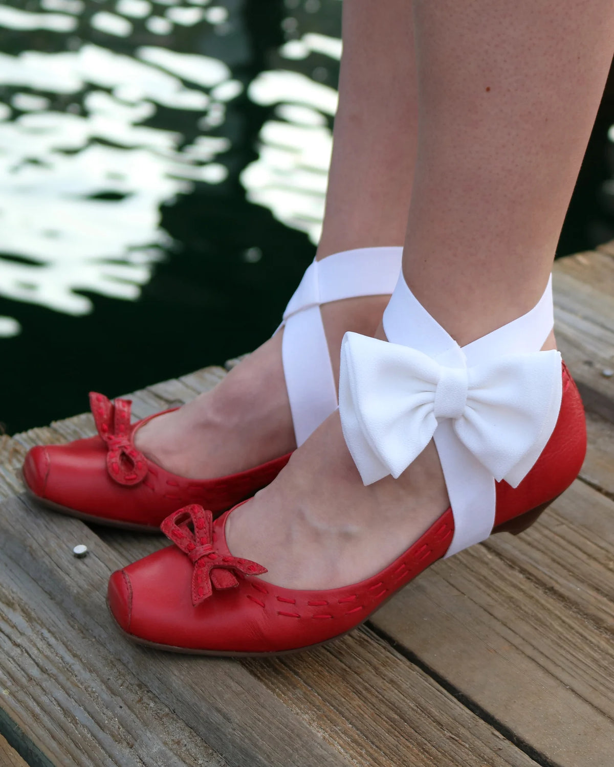 White bow LYNKS styled over red shoes